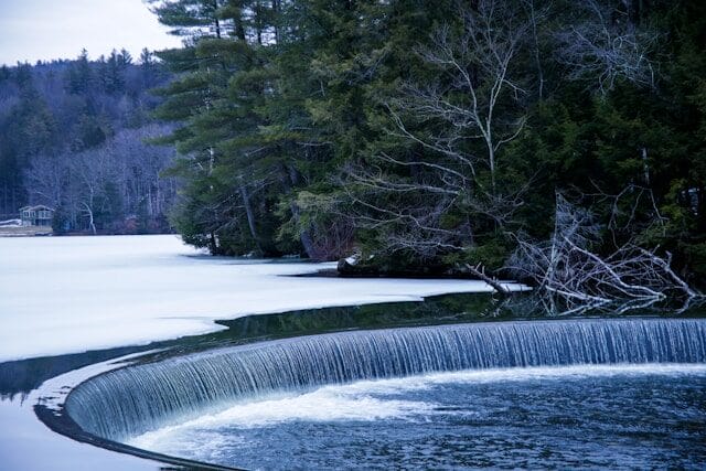 Waterfall over a wintry pond