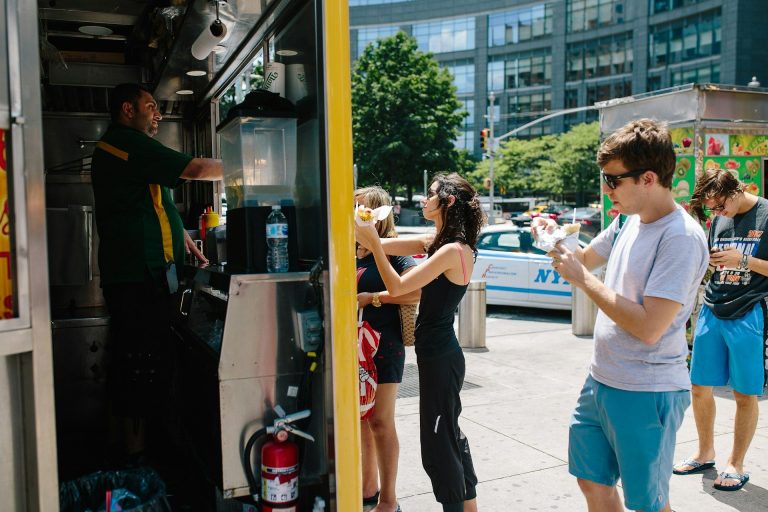 New York City food truck serving customers during the summer in NYC