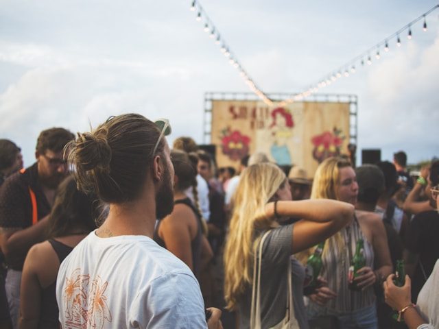 Man standing in the crowd of a strawberry festival in late June