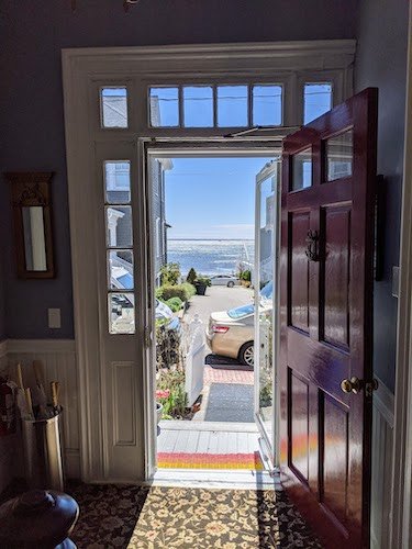View out the front door of The Prince Albert Guest House, looking onto Commercial Street of downtown Provincetown