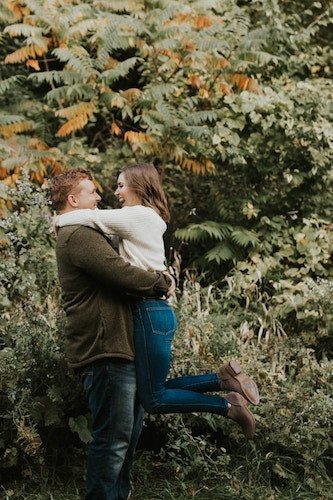 Couple in a serene park with a stunning backdrop of Connecticut for engagement photos