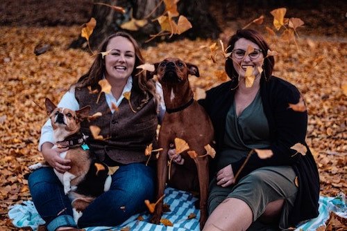 Lesbian couple at their engagement session on a college campus with the whole family