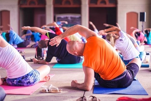 practicing yoga in a large group