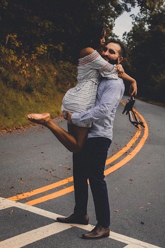 Vibrant foliage and picturesque water views in Connecticut during an engagement session in the fall season