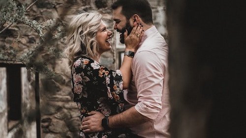 Engaged couple posing in front of an historic building in Connecticut