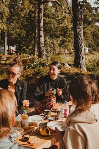 Group of friends enjoying a luxury safari tent in the wilderness of New England