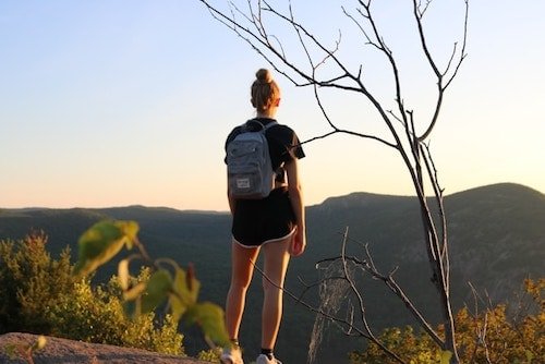 Female hiker at the summit of Bull Hill, one of the best hikes in upstate New York
