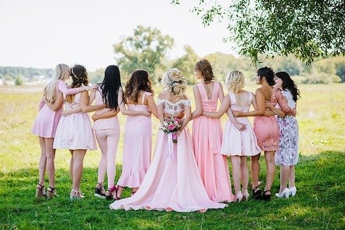 Bridal party taking photos in front of panoramic views of Long Island Sound