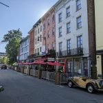 Vintage cars and historic buildings line a block of Rondout, one of the best things to do in Kingston NY