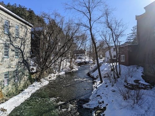 Tranquil Kedron Brook in Woodstock VT, with a former factory to the left