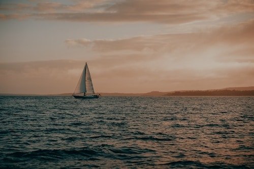 Sailboat passing through Rockland Harbor near Camden, Maine