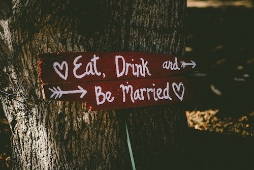 Sign pointing to the rehearsal dinner and wedding celebration for a weekend celebration
