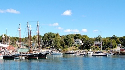 Yachts, sailboats, a harbor park, and lobster boats in the Camden harbor in Camden, Maine