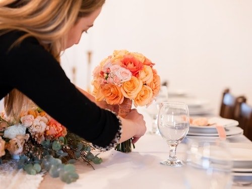 Setting the table with fresh flowers for brunch receptions of a morning wedding