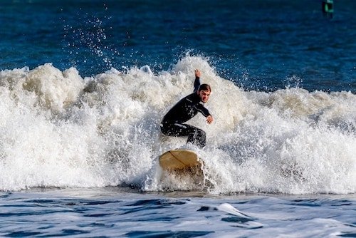 Surfer plying the waves of Avalon, New Jersey