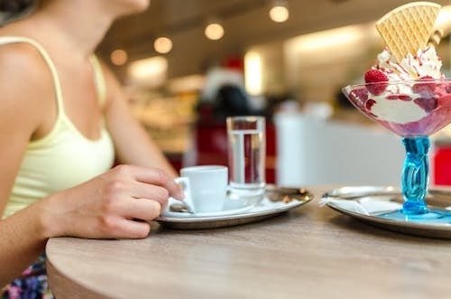 Best Ice Cream In Ct: Top 13 Most Unique Spots 10 Woman enjoying an espresso with her ice cream sundae