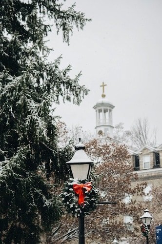 Snow falling on a charming New England winter getaway
