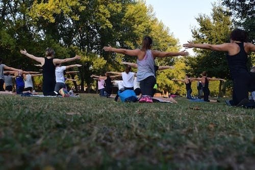 Students at an outdoor Greenwich studio, led by an instructor