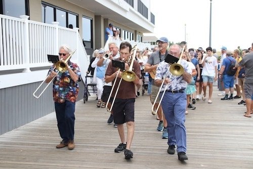 Illustration of a vibrant boardwalk with families enjoying various attractions in Rehoboth Beach