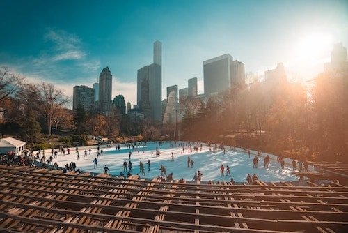 Skaters plying the ice in Central Park, one of the best winter sports to do in NYC this time of year