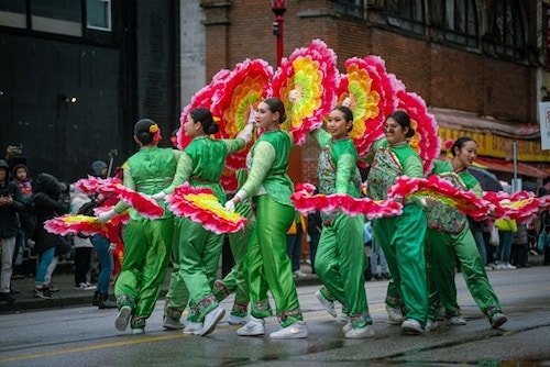 An illustration of the Lunar New Year Parade in Chinatown, filled with vibrant colors and cultural elements.