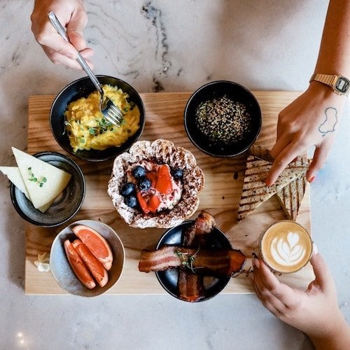 Patrons of restaurants on this list grabbing food from local purveyors