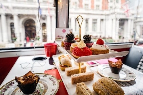 Luxurious hotel afternoon tea setup with exquisite pastries and tea selection. And all followed by a mixed green salad.