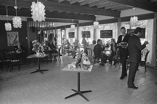 Vintage photo of a steakhouse, waiter smiling