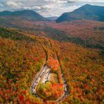 Aeriel shot of the Kancamagus Highway during peak fall foliage season, one of the best things to do in Lincoln NH