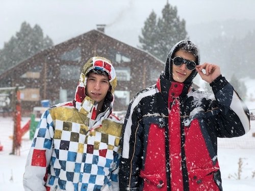 Two friends about to go snow tubing in New Hampshire, another one of the most popular winter activities on New England winter getaways