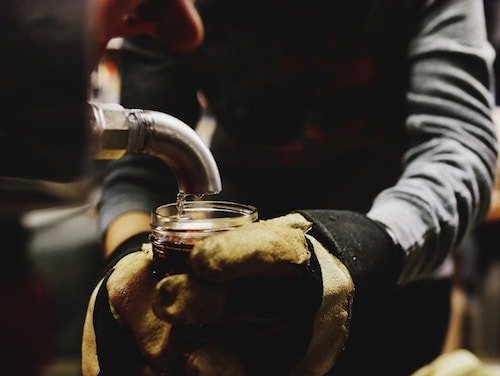 Pouring maple syrup into a jar