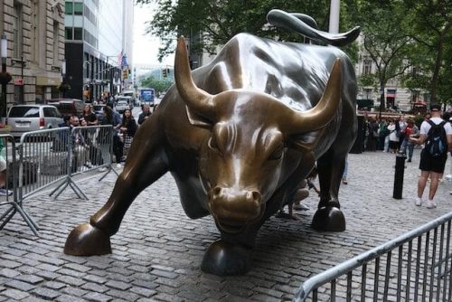 Charging Bull statue with tourists on Wall St in the Financial District
