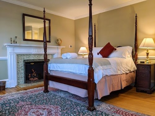 Romantic Bed And Breakfast In Ct: Top 10 Most Unique Spots 2 A guest room at the best bed and breakfast in Connecticut with a four poster bed, fireplace, and private balcony