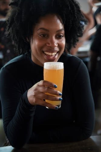 Woman holding a full beer