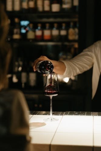 Pouring a glass of wine at one of the most romantic restaurants in Milford CT