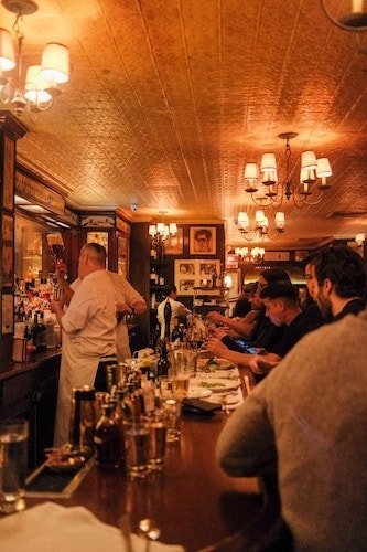 Group of friends together for a drink in a cozy tavern