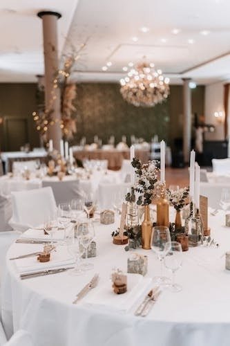 Tables all set for friends to gather at an event space with professional staff in New London