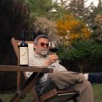 Man enjoying the music with a glass of wine at one of the best wineries in CT with live music