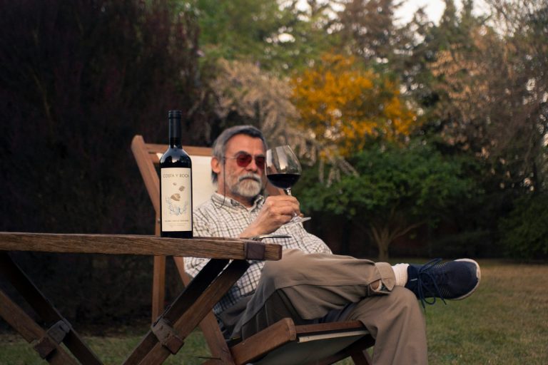 Man enjoying the music with a glass of wine at one of the best wineries in CT with live music