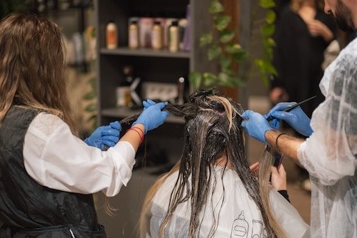 Woman getting hair extensions at a greenwich salon