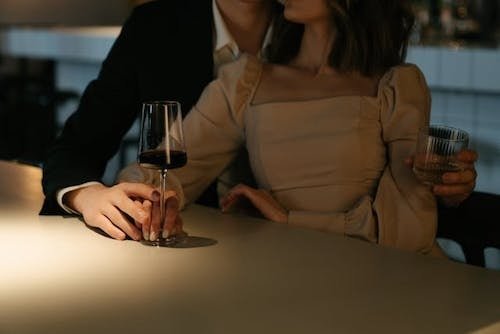 Couple enjoying a glass of wine together at a romantic restaurant