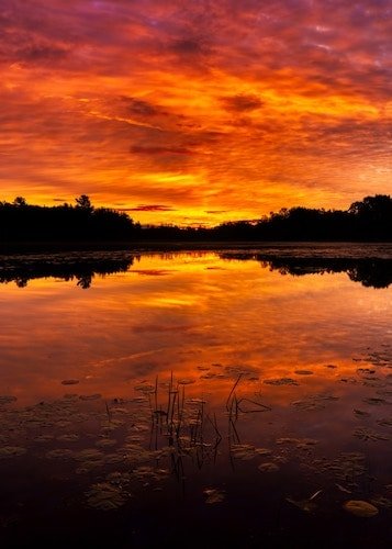 Sunset over a lake in the town of thompson ct