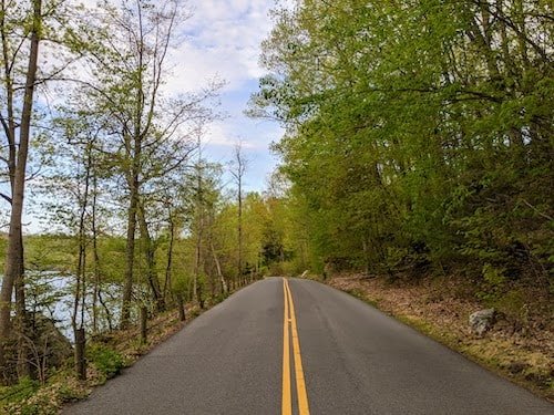 Quiet road around Lake Waramaug located in Warren, Connecticut, where you'll see a big house or two with waterfront views