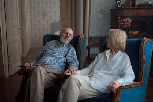 Man and woman sitting in a guest room of a bed and breakfast close to mountain biking and hiking trails near the Connecticut River