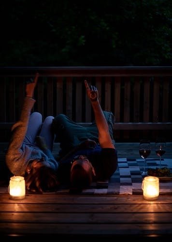 Couple looking at the stars on a romantic escape to a charming coastal town like Cape Cod or Bar Harbor, Maine