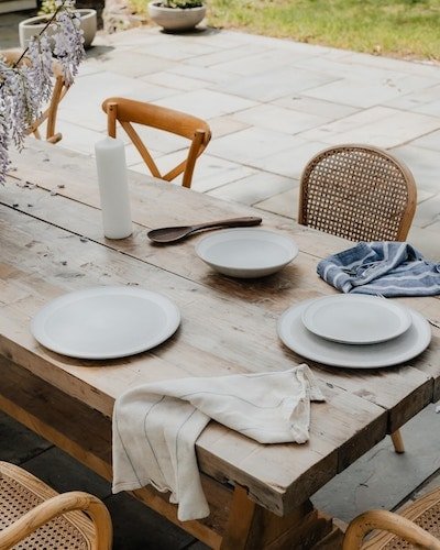 A table set for dinner or tea on the patio of a quiet cottage
