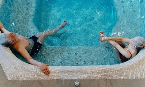Mature couple indulge in a spacious hot tub together