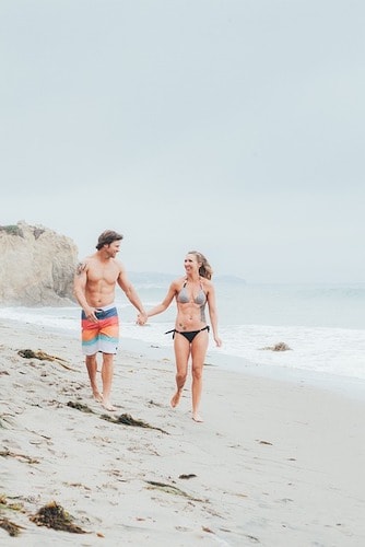 Couple walking together on the beach, fresh salt in the air