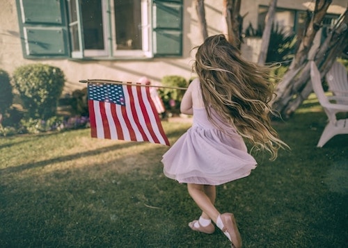 Young girl playing with flags