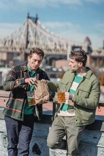 Two man celebrating St Patty's Day with beer and food